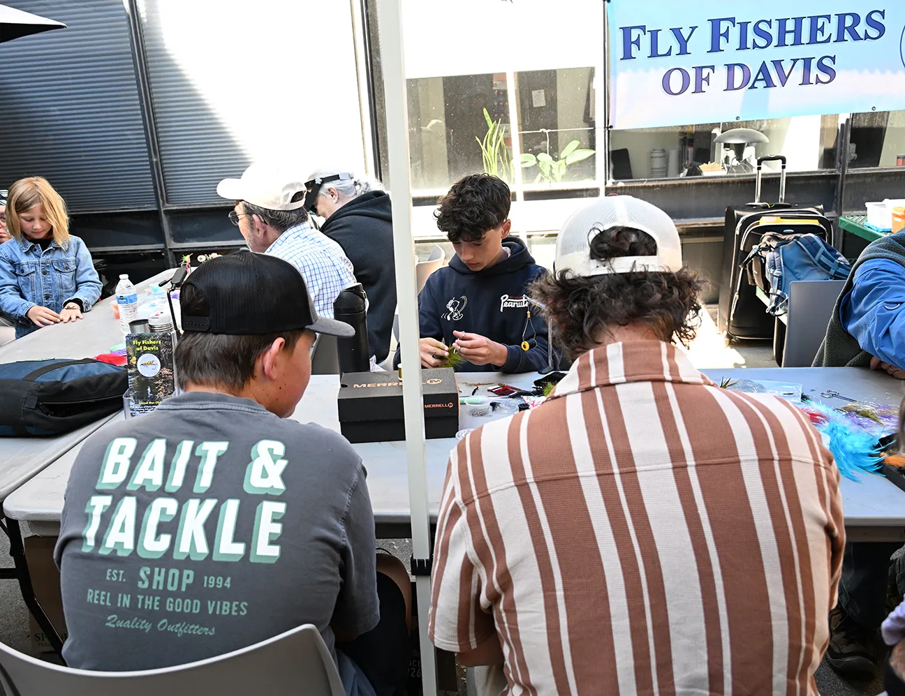 Elijah Brownstein, the youngest member of the Fly Fishers of Davis talks to attendees. 