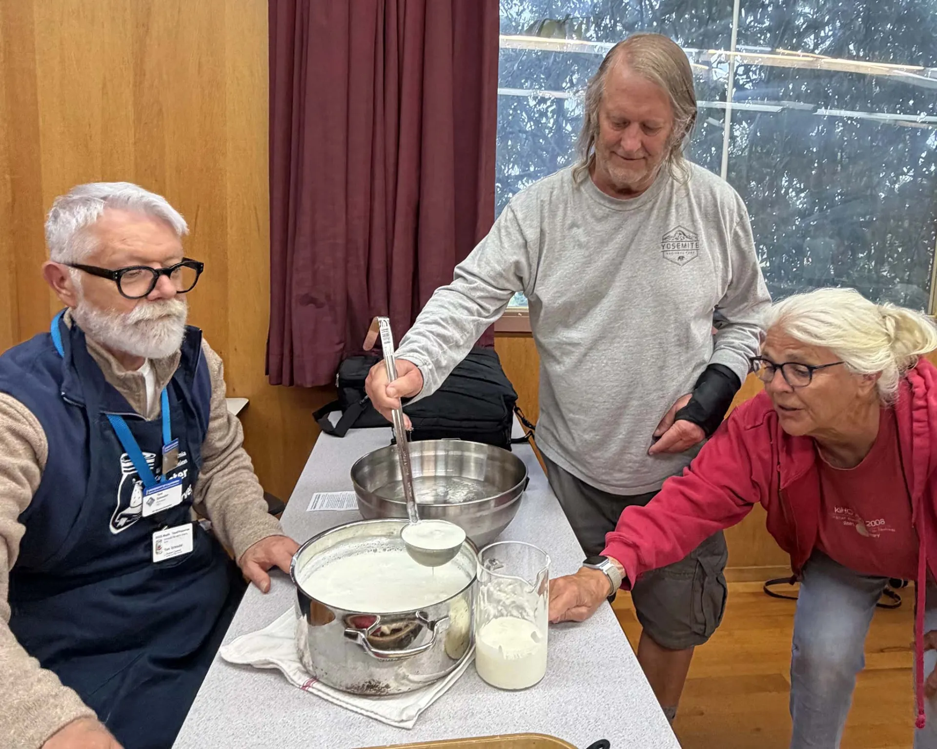 Filling the jars with the yogurt-inoculated milk for incubation.