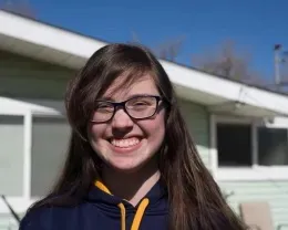 Smiling youth with strong overhead lighting