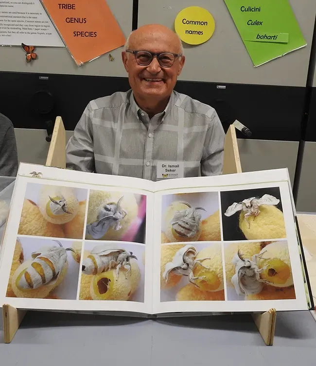 Dr. Ismail Seker and his book on silk moths. (Photo by Kathy Keatley Garvey)