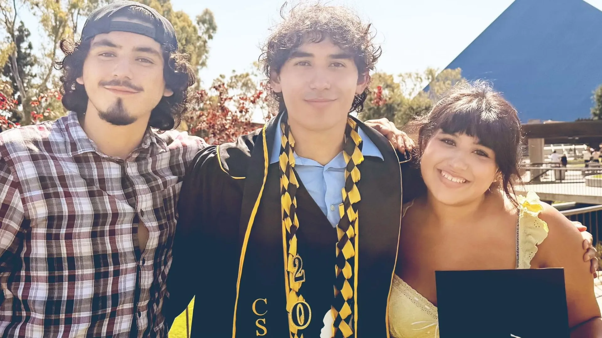3 young adults celebrating a graduation