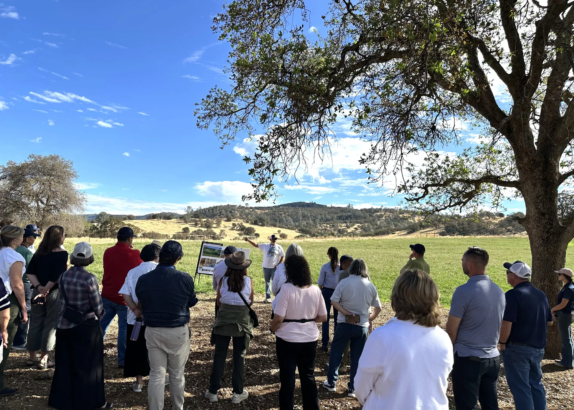 Toby O'Geen addresses the tour group under a tree at Sierra Foothill REC