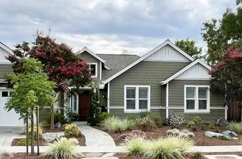 garden planted with diverse ornamental plants that grow year-round, and fir bark mulch