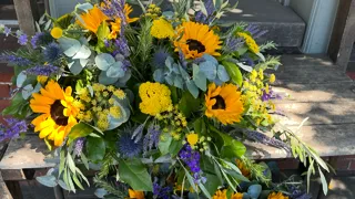 bouquet of flowers mixed with herbs and tree branches