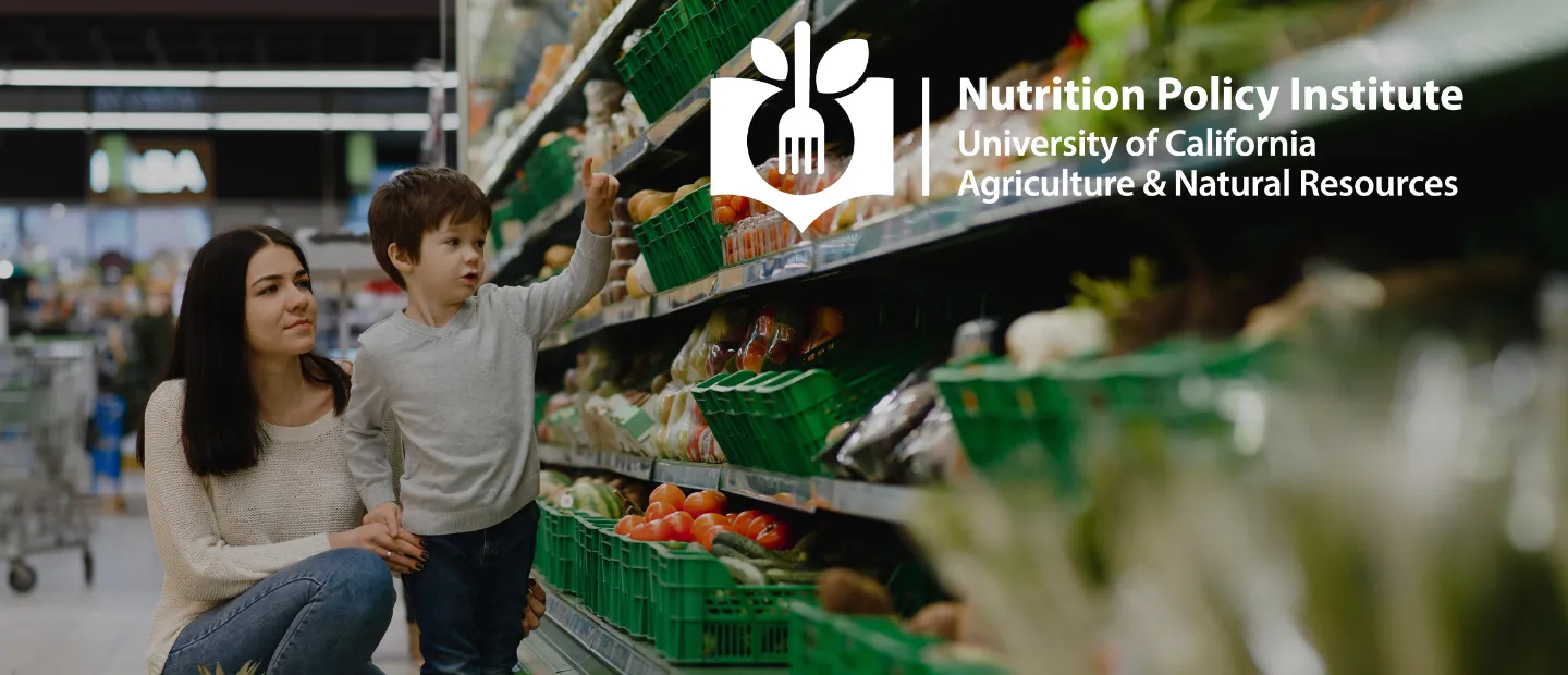 A mother and her young son pick out produce in the grocery store produce aisle. The Nutrition Policy Institute logo is included.