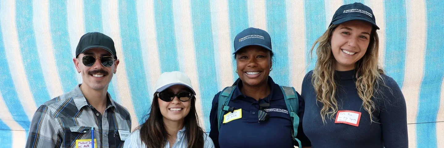 San Diego team four staff members smiling at camera