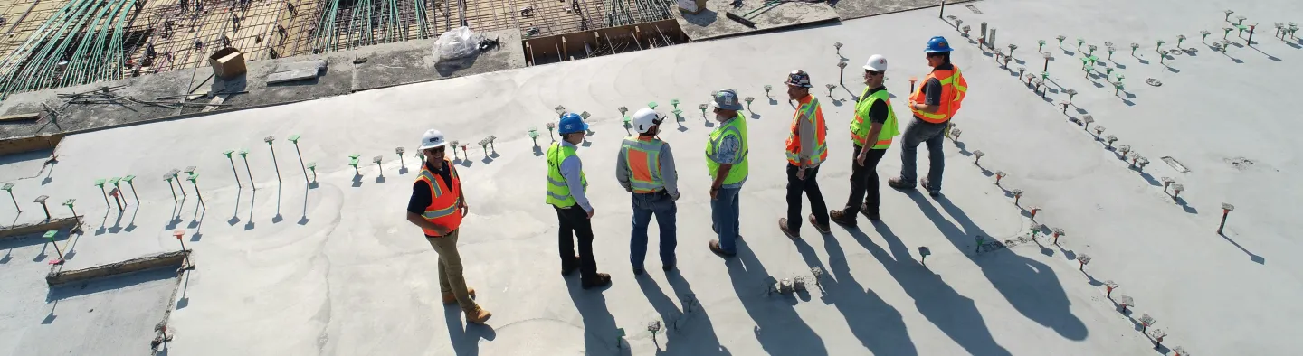 A group of construction workers looking out onto a site