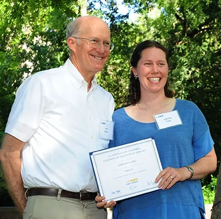 UC Davis vice provost Ken Burris, former interim provost and executive vice chancellor, presents the award to Tabatha Yang. (Photo by Kathy Keatley Garvey)