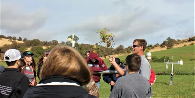 Jeremy James shows students SFREC CIMIS weather station equipment and how it relates to natural landscapes & agriculture.