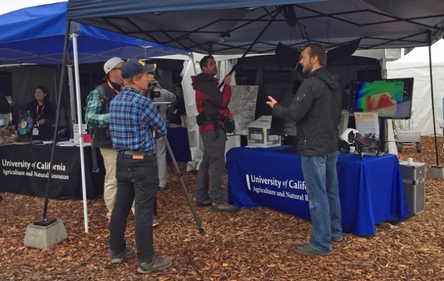 A PBS news crew interviews Andy Lyons and Jacob Flanagan.