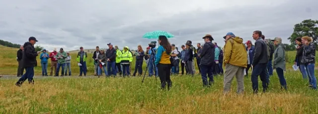 UCCE advisor Dan Macon, far left with cap, speaks to participants at the workshop.
