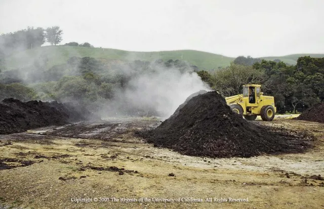 Turning a compost windrow