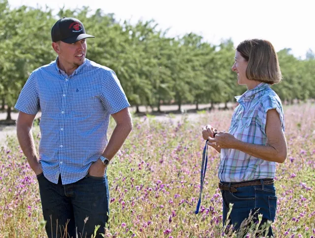 UCCE advisor Rachael Long, left, talks with a Yolo County grower about hedgerows. UCCE advisors serve Californians in one or more counties.