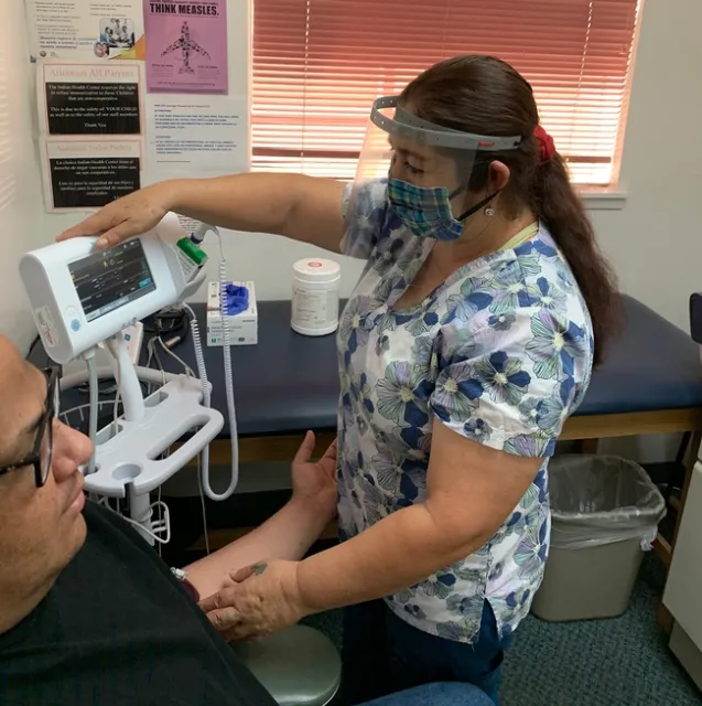 Health care worker with mask and face shield