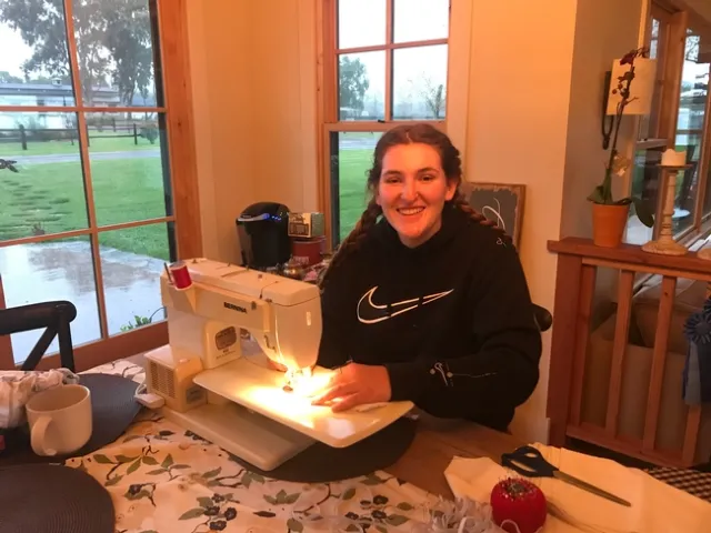 Olivia at her sewing machine