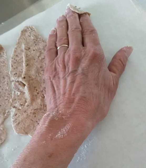 Laying out cracker dough on cookie sheet(3)