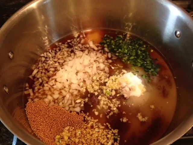 Ingredients in saucepan except for plums