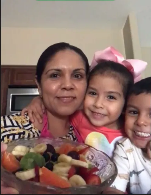 Family showcasing their Summer Fruit Salad recipe.