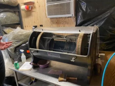 A cylindrical metal piece of equipment sits on a countertop.