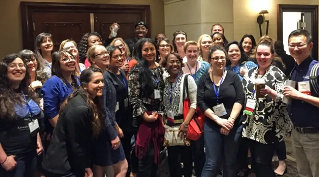 A crowd of smiling men and women.
