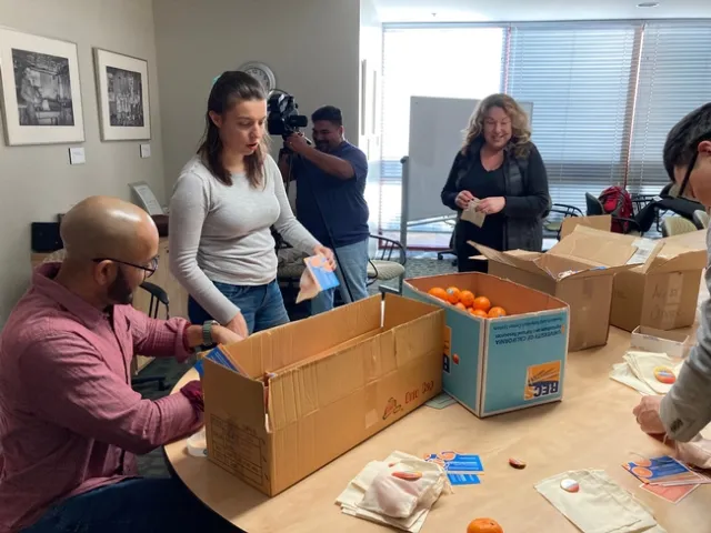 From left, Hanif Houston, Lucie Cahierre, Miguel Sanchez, Evett Kilmartin and Mike Hsu prepare bags of the UC variety Tango mandarin to give to legislators while inviting them to Ag Day at the Capitol the day before the event.