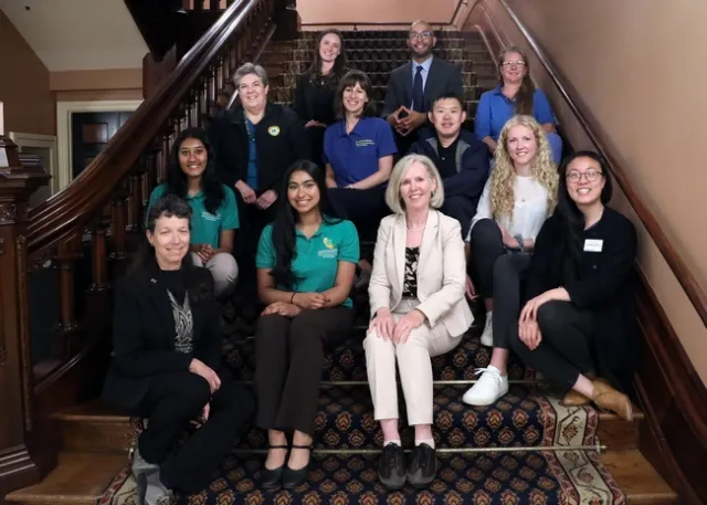 A group of people sit on a staircase.