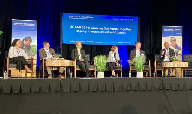 Six people sit on stage under a banner that reads: “UC ANR 2040: Growing Our Future Together, Aligning Strengths for California's Success”