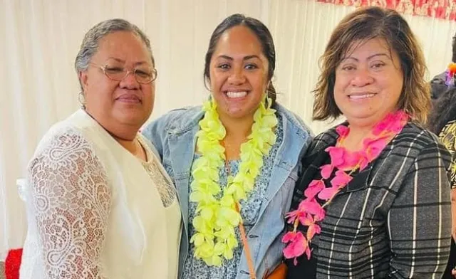 Three women smiling at the camera.