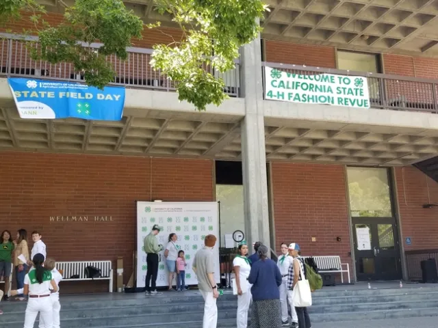 Picture of Wellman Hall at UC Davis. Outside is an area where students can take pictures agains a big 4-H backdrop.