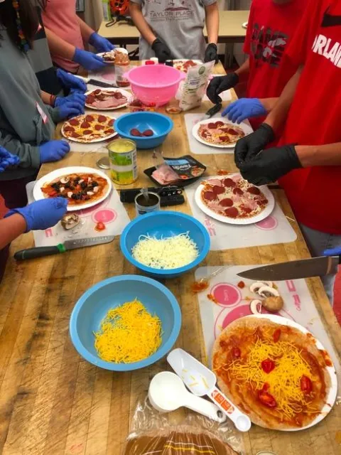 Los estudiantes de Teens Love Cooking preparan pizzas al estilo “Myplate”.