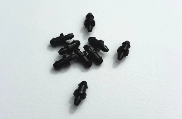 A few tiny, black plastic goof plugs.