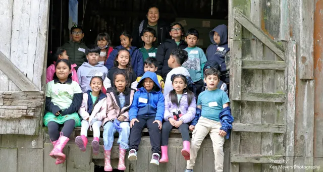 Class posing in the barn