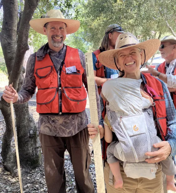 A man and woman holding a baby