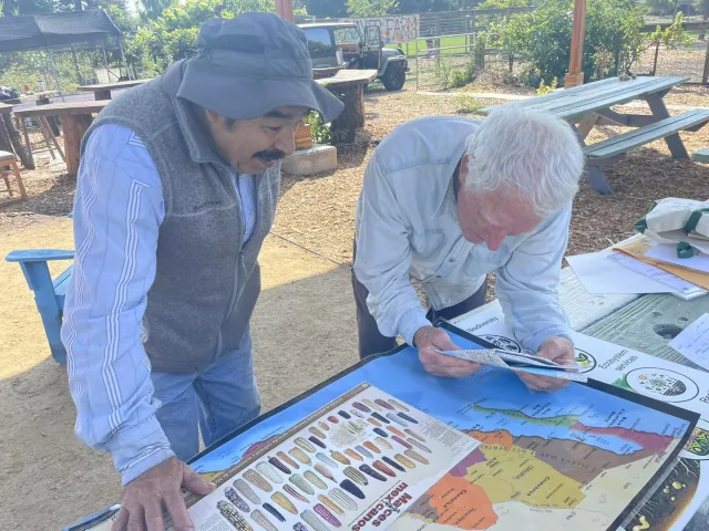 Micheal Knappman speaking with a Bayer Farm Gardener.