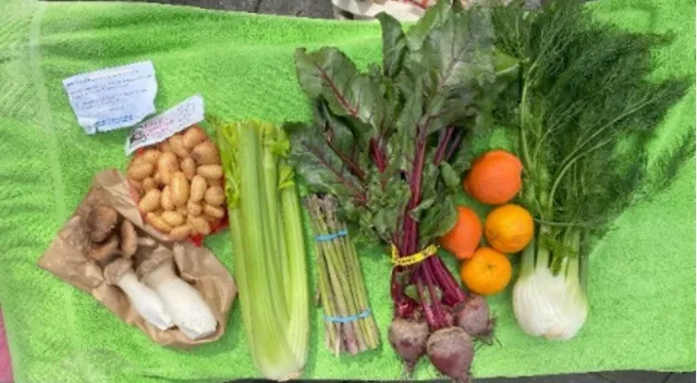 A collection of fresh produce laid out on a green towel.