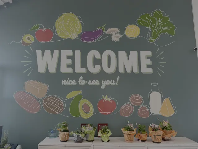 A colorful sign welcoming clients to a food bank.