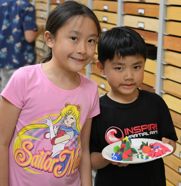 Siblings Amanda Qian, 9, and Cody Quian, 6, show the arachnids they created. (Photo by Kathy Keatley Garvey)