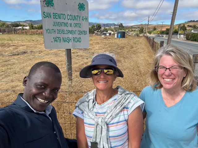 Emily Jane Freed (middle) visits with Hedmon Okella, 4-H animal science advisor (left) and Julie Katawicz, community education specialist for the 4-H Youth Program