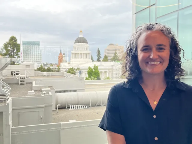 Hannah Thompson poses with Capitol behind her