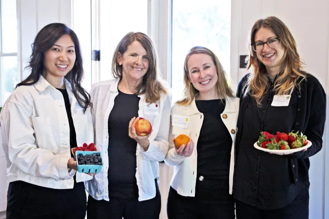 From left, Heile Gantan-Keo, Wendi Gosliner, Kassandra Bacon and Leslie Soble pose while holding a variety of fruit