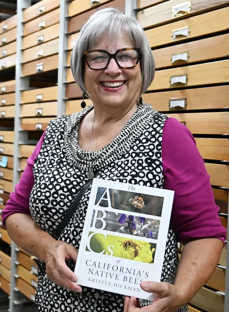 Tece Stich Markel, board member at UC Master Gardeners of Placer County, holds the book, "ABC's of California's Native Bees."