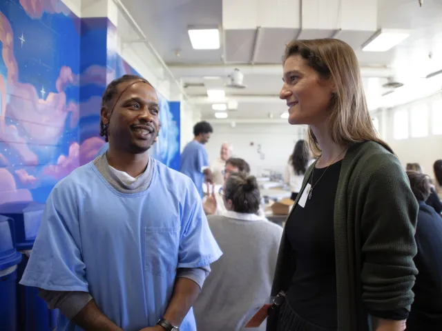 Farmer Sarah Weil, right, speaks with an incarcerated resident at the Solano facility