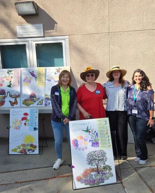 A group of 4 women holding informational signs.
