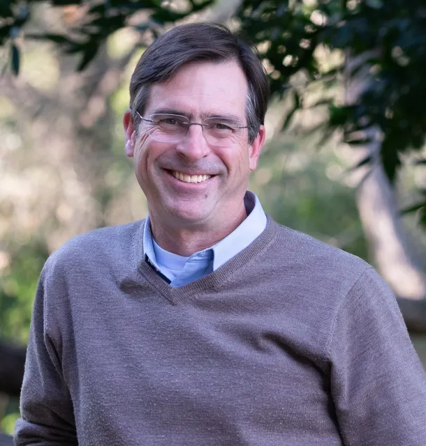 David Lewis smiling at the camera