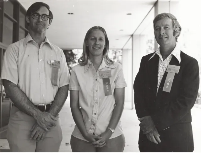 Three people standing in a row