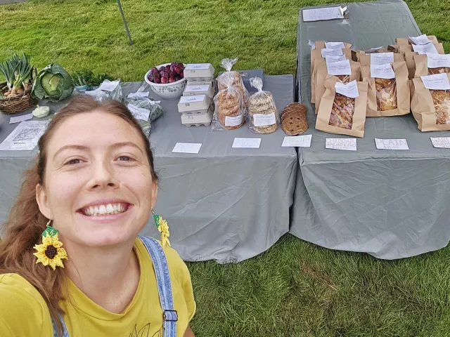 Ary West sells produce and baked goods from Trouble Valley Farm at a Modoc Certified Farmers Market table