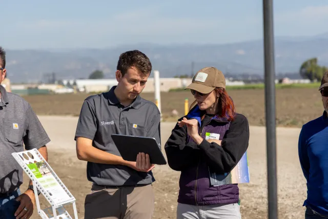 Ag tech company representative discusses the technology with an attendee during a field demonstration at Hansen Agricultural Research and Extension Center