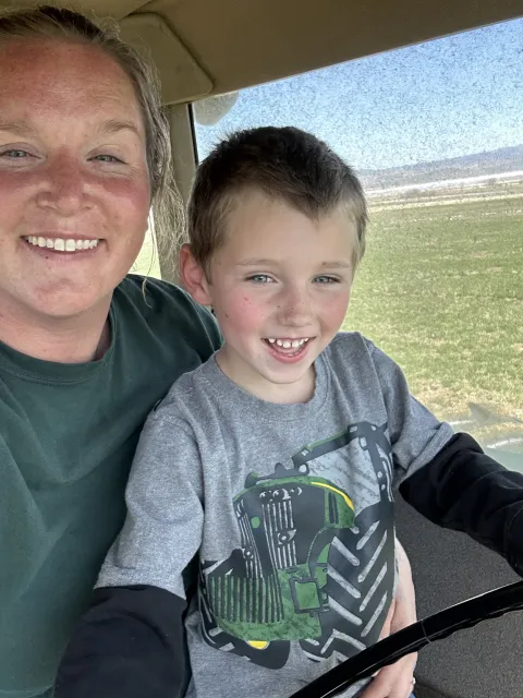 Kelsey Arreche and her son pose for a selfie while working on their ranch