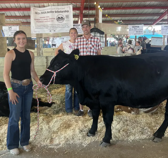 2024 Scholarship winner, Olivia Laws of Yreka FFA, pictured with Robert and Laura Martin, Pioneer Cattle Co., who donated her bred heifer.