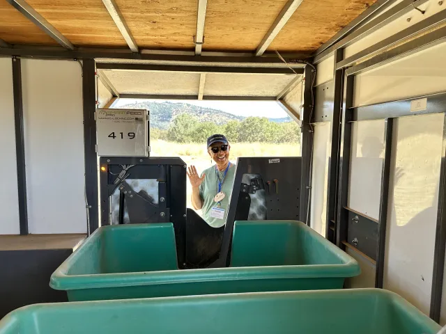 Sharon Nance waves as she inspects the Smart Feeder system's bins
